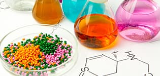 Bottles of chemicals and plastic pellets illustrates PlusChem's expertise in Additives