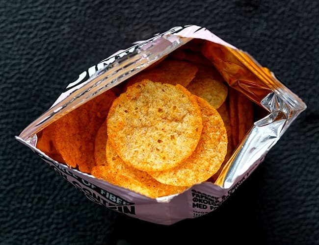 Delicious snacks in an open bag illustrates PlusChem's expertise in the Food and Feed industry