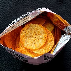 Delicious snacks in an open bag illustrates PlusChem's expertise in the Food and Feed industry