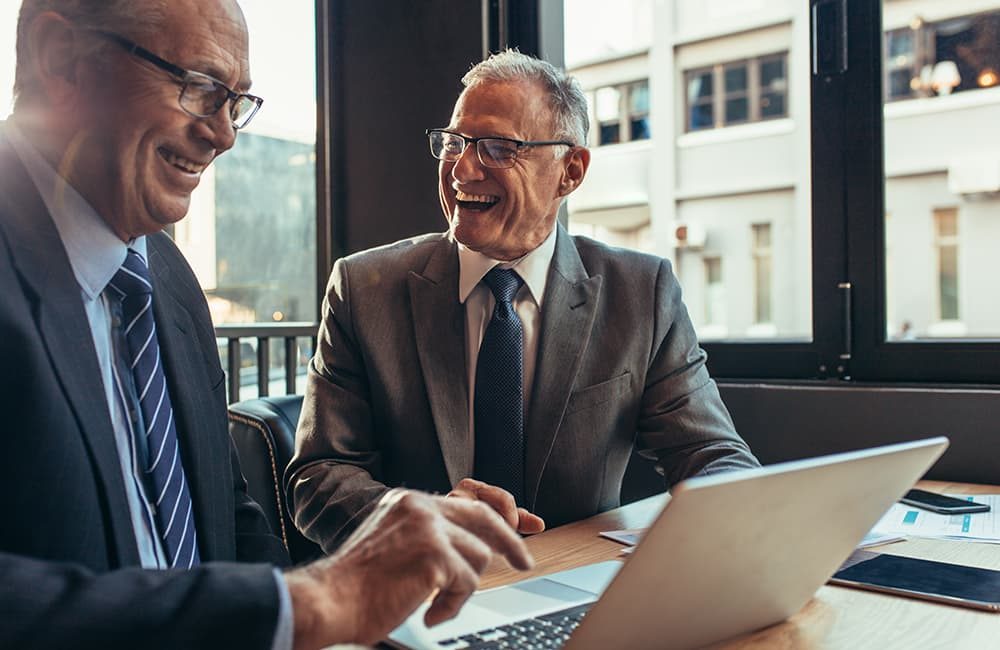 Two men enjoying a lighter moment during business negotiations